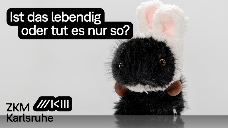 A plush robot guinea pig dressed as a rabbit