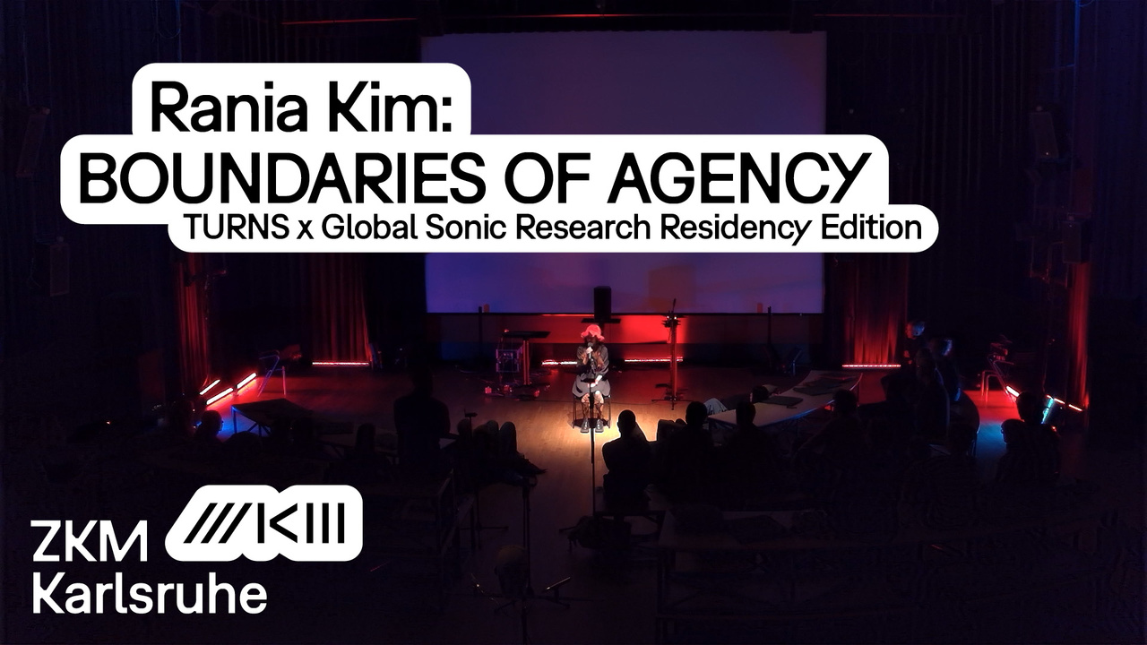 Rania Kim sits in the middle of a stage lit in blue.