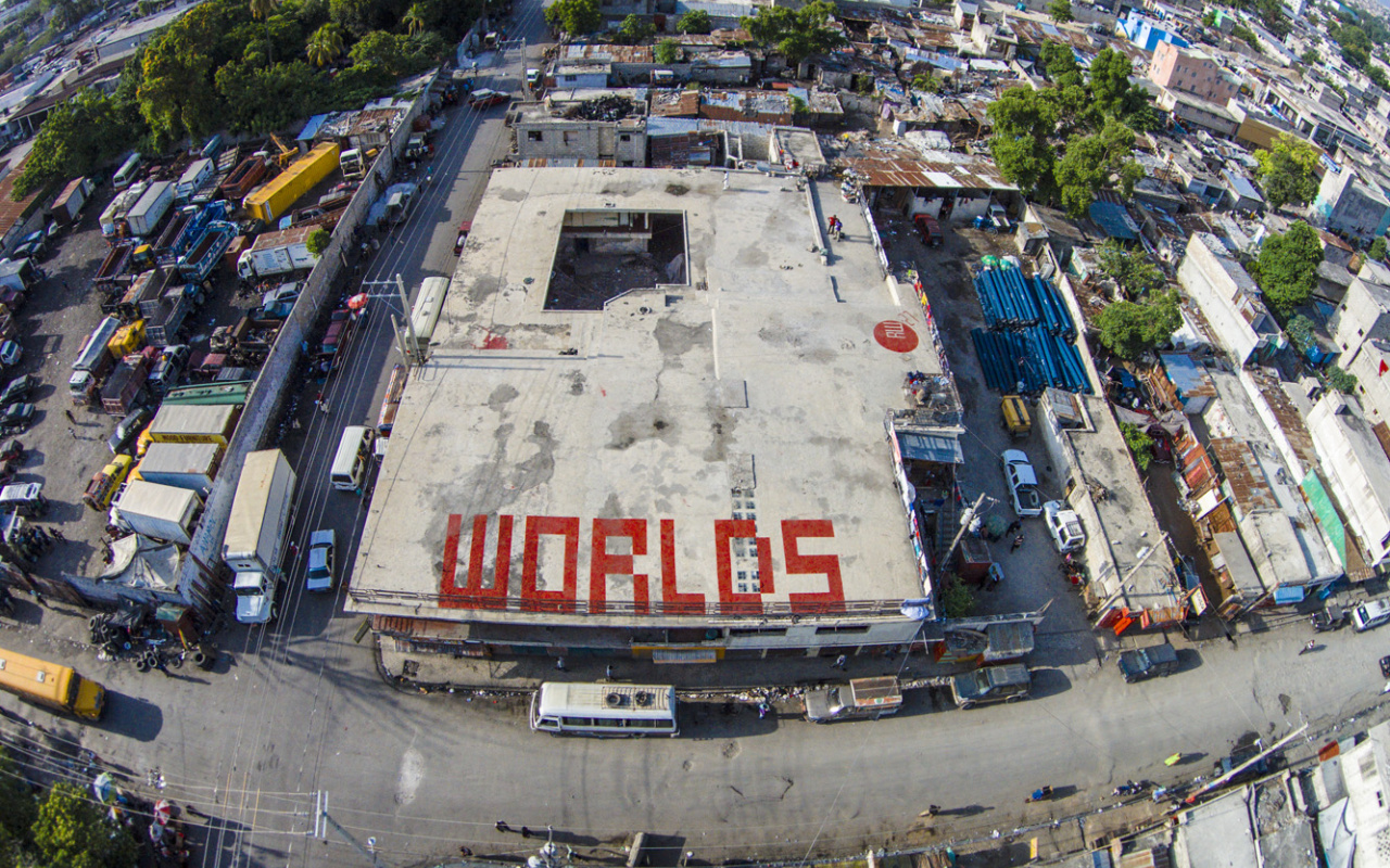 The word "worlds" written in big red letters on a roof top in haiti, view from above
