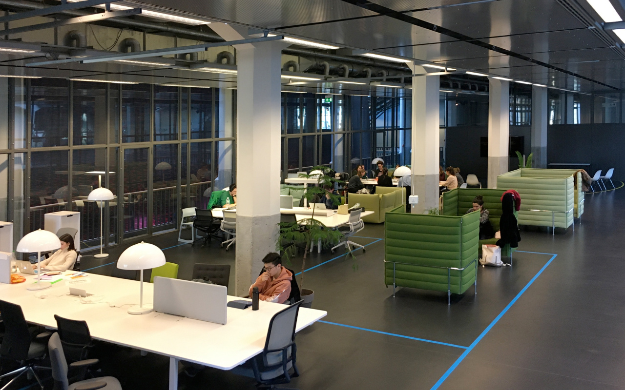 View of the ZKM Media Lounge: tables, chairs and readers