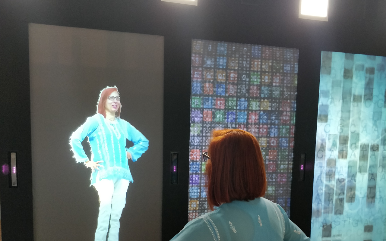 A woman faces her digital reflection