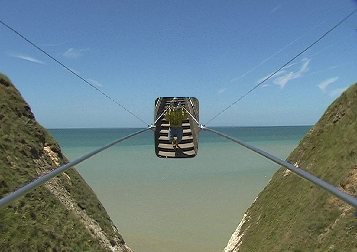On the left and right side a wooded catfish protrudes into the picture. Between sea and sky share the picture. In the exact center of the picture a mirror is stretched on wire ropes, on which a person can be seen on a stone staircase.