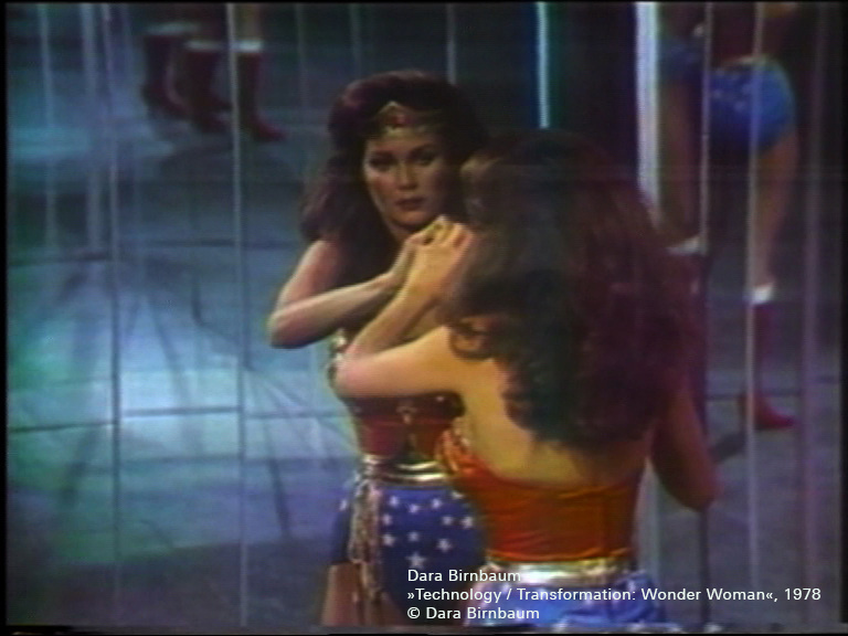 Wonderwoman looks at herself in the mirror