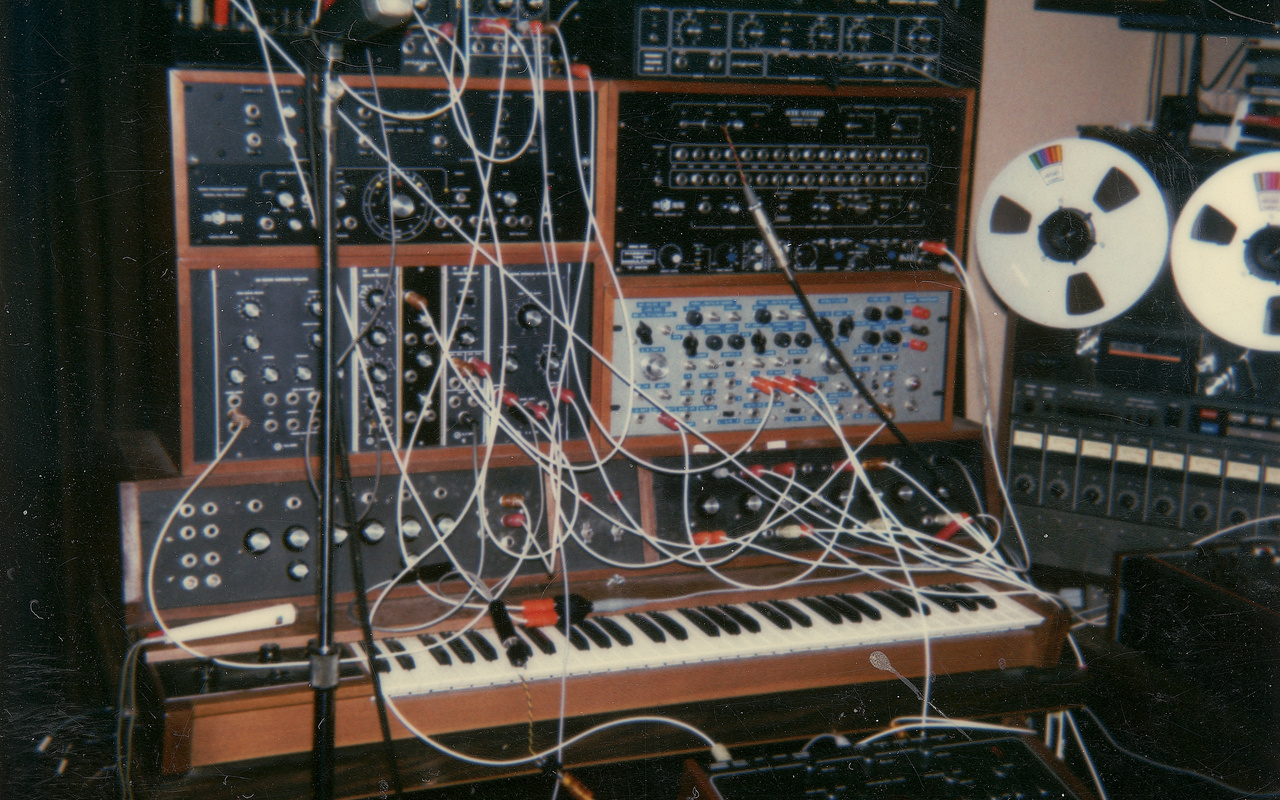 The picture shows a part of an analog music studio with many cable connections.
