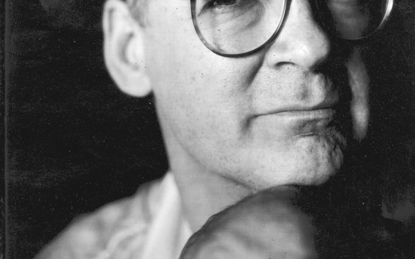A black and white portrait of Tony Conrad