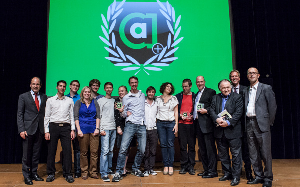 People standing in front of a green background