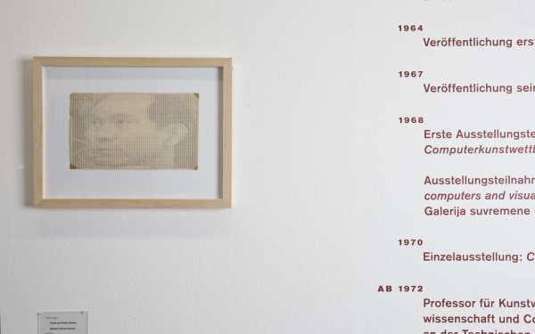Blick auf eine weiße Wand: Links ein Portrait von Hiroshi Kawano, rechts sein Lebenslauf.