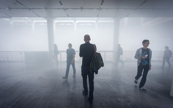 People walking through fog