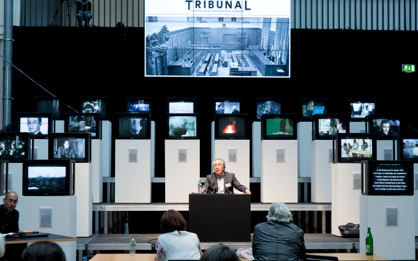 A man sitting in front of several screens