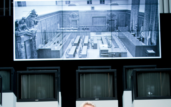 A man sitting in front of several screens