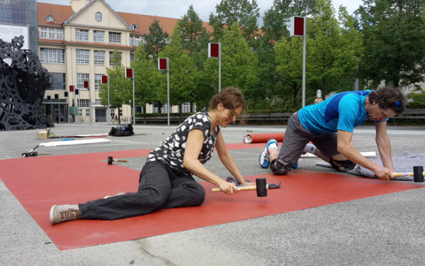 Two persons working on the ground