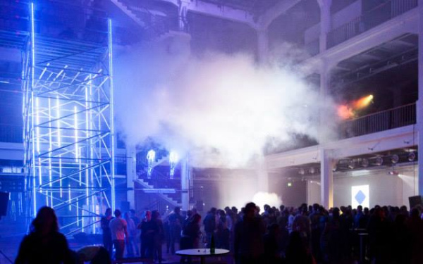 People dancing under a cloud in a closed room