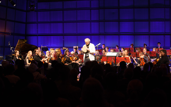David Amram in front of an orchestra
