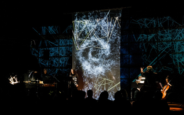 Musicians in front of an LED wall with visualizations