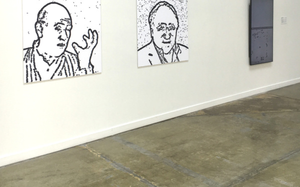 Two portrait drawings on the wall 