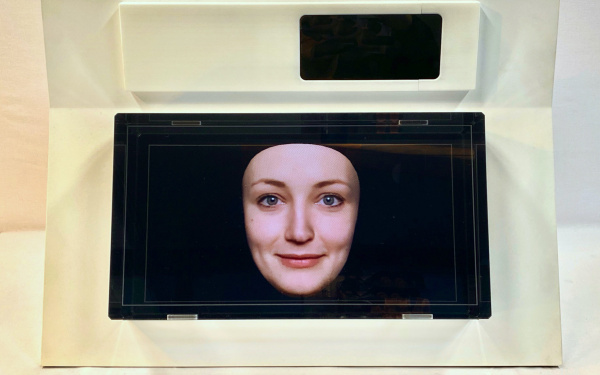 A small screen shows a female face against a blue background.