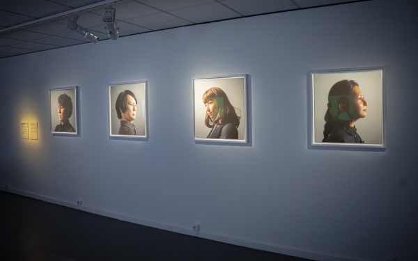 Maija Tammi, »One of Them Is a Human, #1-4«, 2017. On display are four portraits, showing different people, on one wall. 