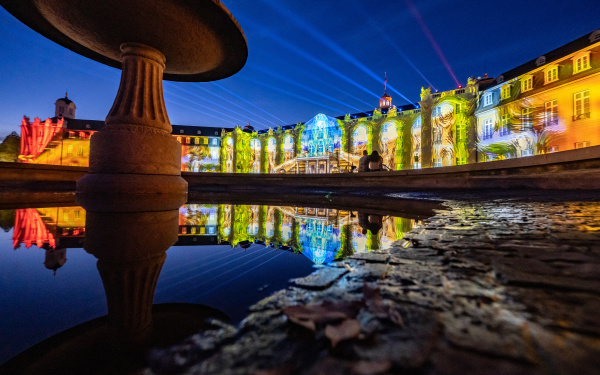 You can see the colorfully illuminated facade of the Karlsruhe Baroque Palace.