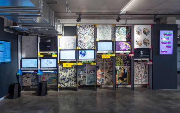 Several screens hanging on the wall with video games