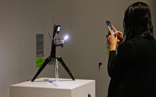 You can see a camera on a tripod filming a crystal.