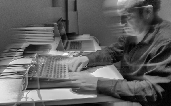 Black and white image of Manuel Rochalturbide sitting at a mixing desk