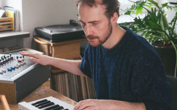 Piotr Kurek during a performance at keyboard and mixing desk