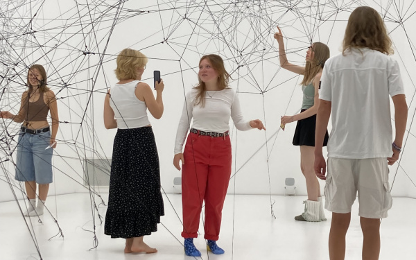 Several people can be seen in an installation. 