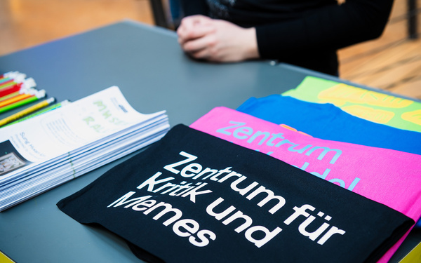 Zu sehen sind bunte Taschen mit der Aufschrift "Zentrum für Kritik und Memes".