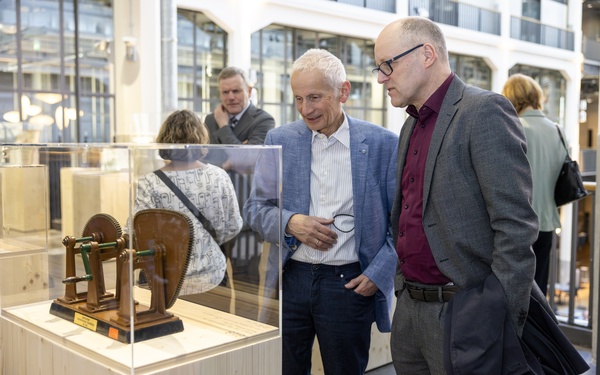 Two people can be seen looking at an exhibit.