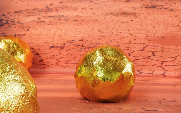Eine goldene Kugel vor einer Mars-Landschaft