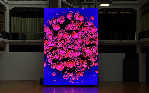 A huge screen displaying an abstract work of art.