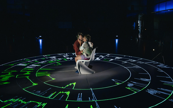 Two people are kissing at the “E.E.G. Kiss.”