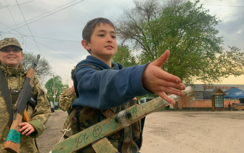 A boy stretches out his hand