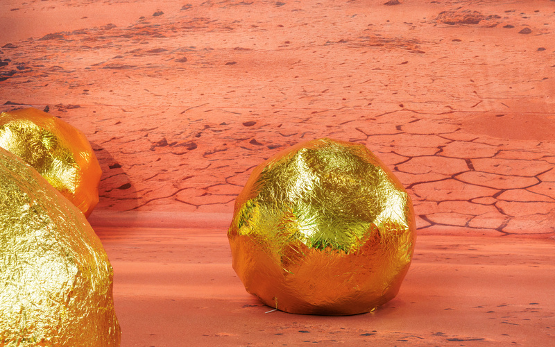 Eine goldene Kugel vor einer Mars-Landschaft