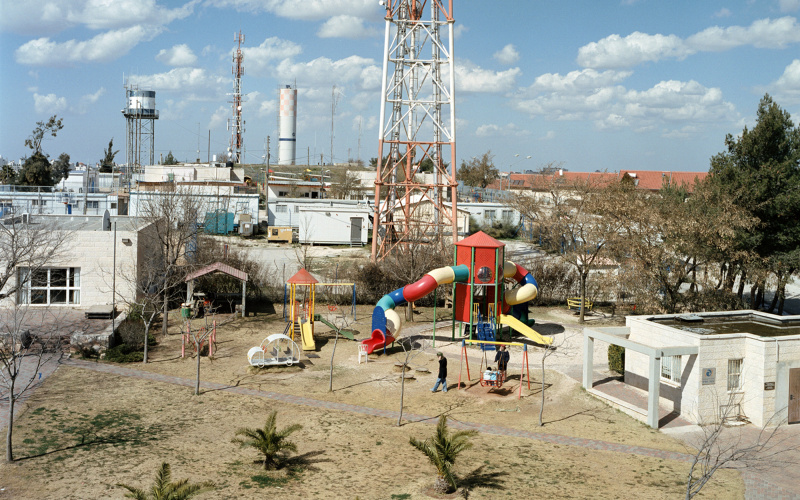 Colourful playing ground in front of a factory side