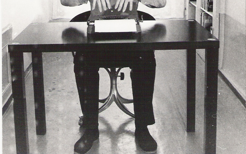 Black and white photography of Gerhard Johann Lischka at his desk with typewriter