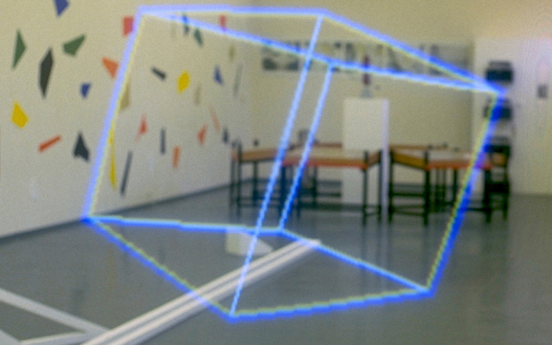 Jeffrey Shaw's "Virtual Sculpture" from 1981 floats as a cube of blue lines in the exhibition space.