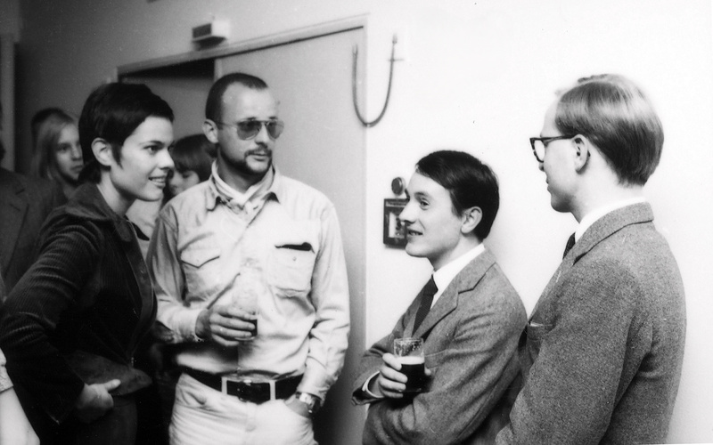A scene from an exhibition opening: Gerry Schum and Ursula Wevers talking with Gilbert & George